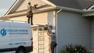 Technician repairing damaged gutter on Shreveport LA home exterior with vinyl siding