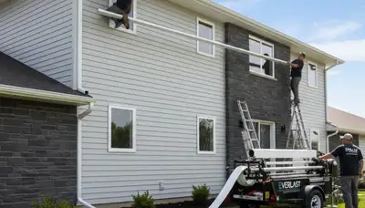Seamless gutter installation on vinyl siding home in Shreveport, LA by Next Level Exteriors